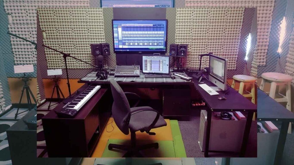 Interior view of a fully equipped recording booth with high-end microphones and acoustic treatment.